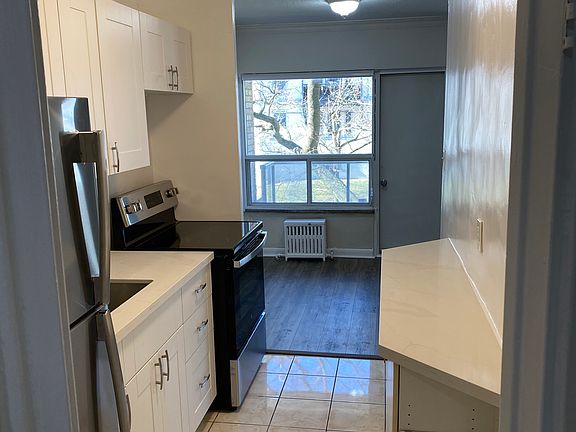 Newly renovated kitchen with quartz countertop and stainless steel appliances.