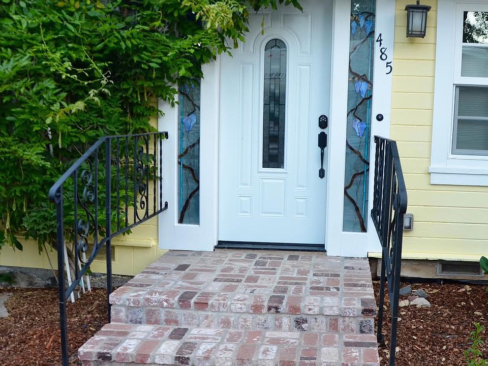 Front of the house showing custom stained glass windows.