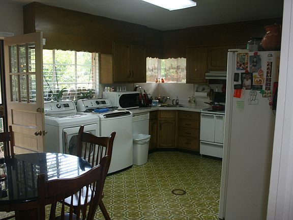 Large Eat-in Kitchen. Washer and dryer hookups are in the kitchen - very efficient! Door on the left exits to the driveway.