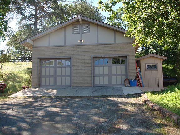 Separate 2-car garage with storage next to the house
