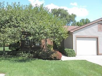 Nice open floor plan with family room off back. Wood burning fireplace in large living room. Ample size 2 bedrooms...one currently used as dining room. End unit includes lots of windows. 1.5 car attached garage with opener. (Monthly condo fee 200)