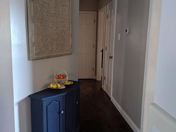 Hallway to the bathroom and 2 bedrooms, there is a pantry and another storage closet.