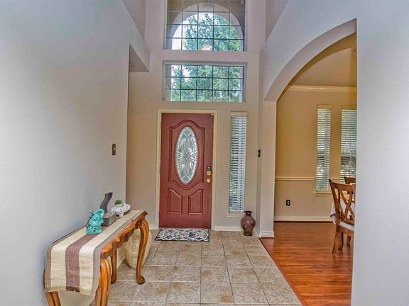 Welcoming entry way opens into formal dining room and living room.