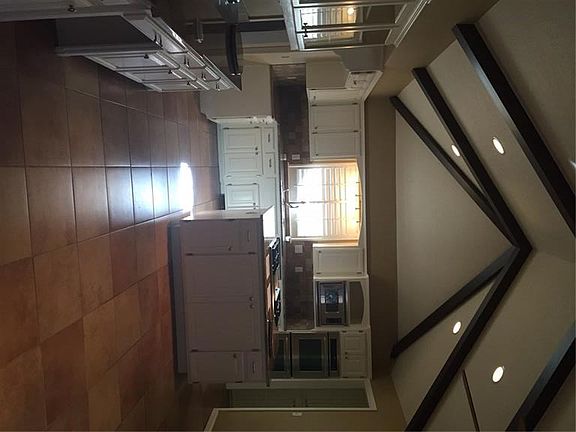 Spacious kitchen with new tile floor and granite countertops.