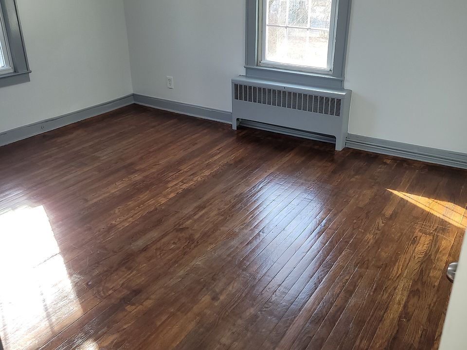 Homey wood flooring in this bright bedroom