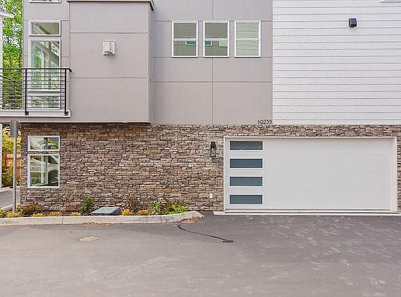 2 car garage with app-controlled garage opener. One Extra open car parking space adjacent to house.