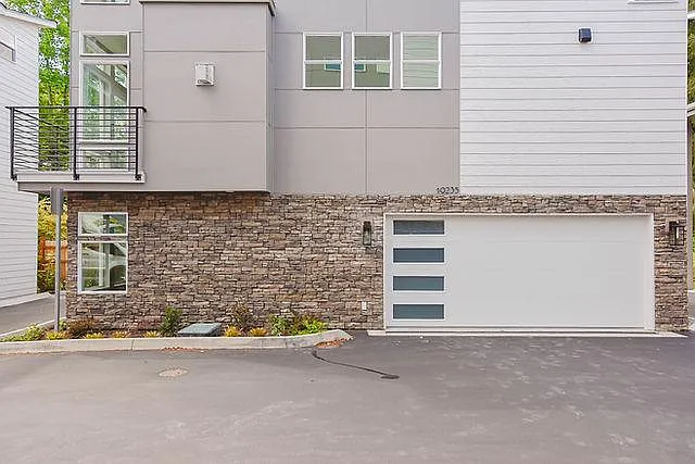 2 car garage with app-controlled garage opener. One Extra open car parking space adjacent to house.