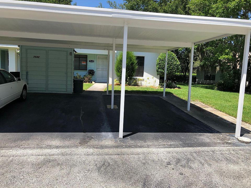 Two car Covered carport with locked storage.