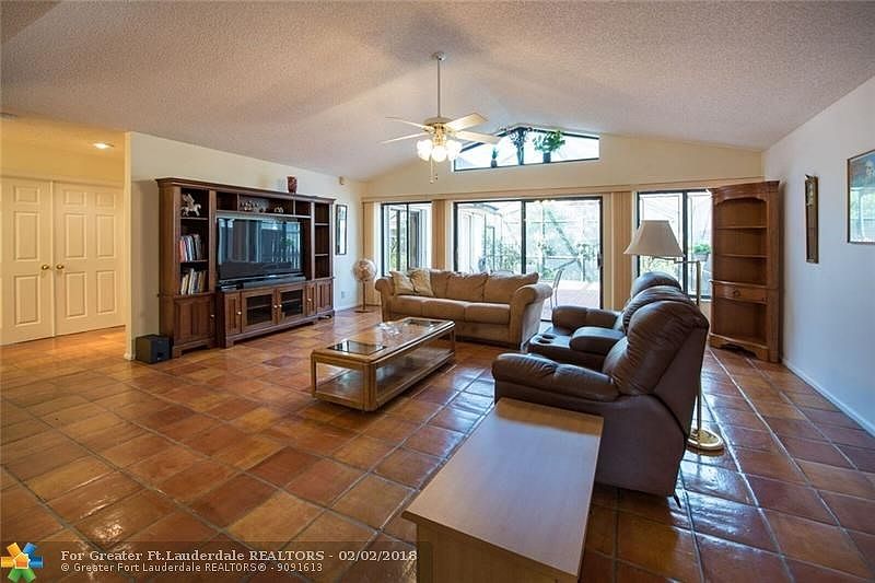 Beautifully maintained - huge living room, with impact transom window leads out to dome screen patio. Accordion Hurricane shutte