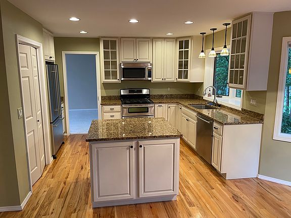 Updated kitchen with granite countertops, Jenn-Air appliances, and great storage
