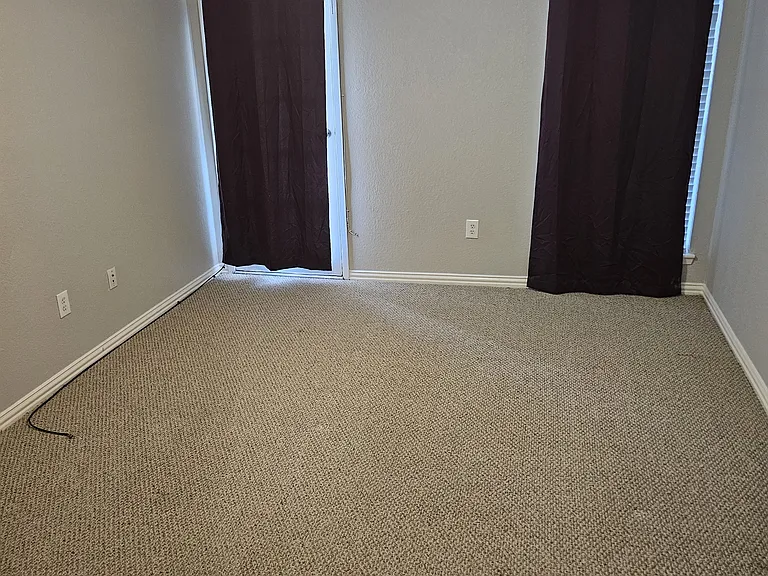 Primary bedroom door leads to the patio