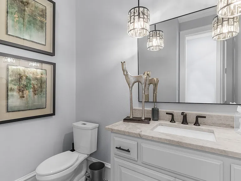 Stylish 2nd-floor powder room featuring elegant crystal lighting and sophisticated finishes.