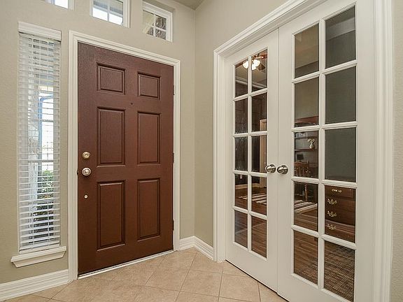 A view of the entry from inside the home. French doors lead into study.