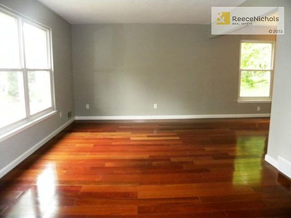 Living room with hardwood floors and neutral paint.