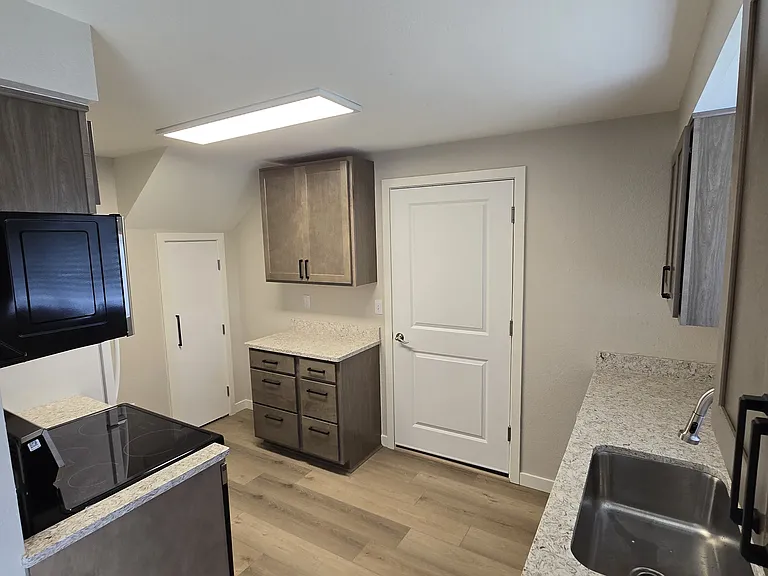 New kitchen! Granite countertops, new appliances, door to garage, and pantry door. Yes - your own built-in pantry!