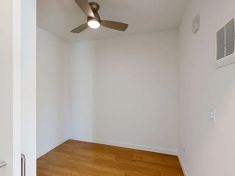 Spacious apartment Bedroom with Wood-Style Flooring.