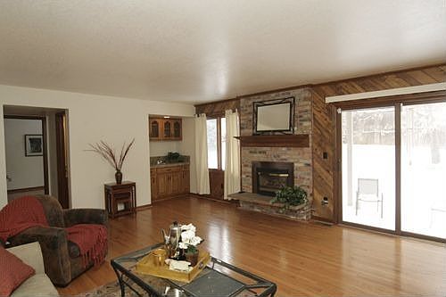 Gleaming hardwood floors, wet bar and inviting fireplace.