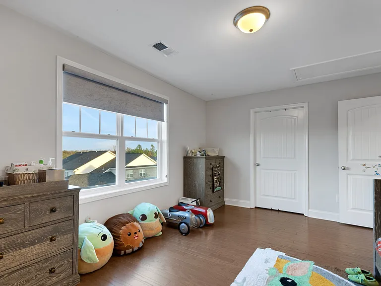 Upstairs Bedroom #2 with walk-in closet featuring custom closets
