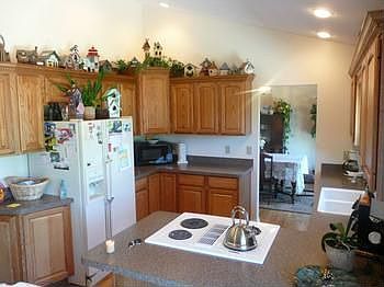 Vaulted ceilings, oak cabinets, hardwood floors and great views of the backyard and pond!