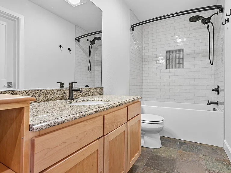 Bathroom with high tub, custom time, and rain shower.