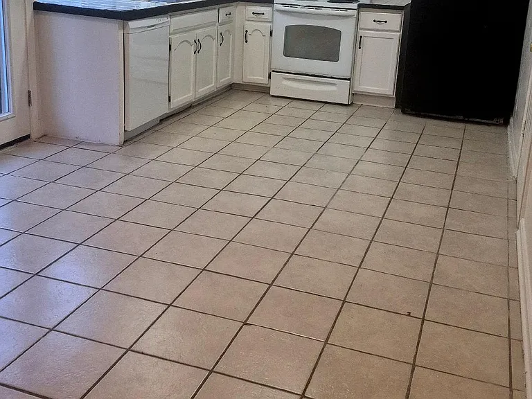 Kitchen with appliances included: stove, refrigerator, dishwasher and garbage disposal