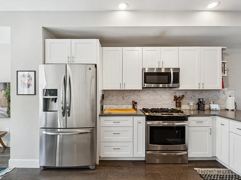 Newer stainless steal appliances and shaker cabinetry