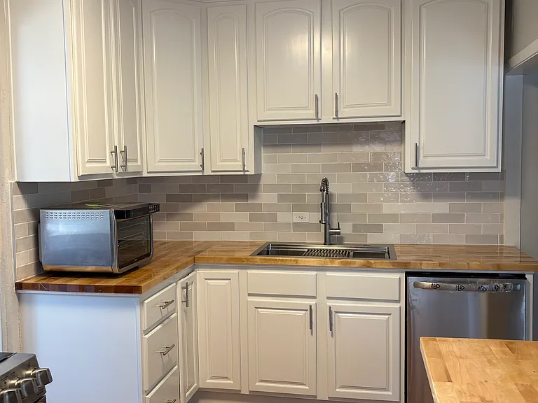 updated kitchen, new sink, dishwasher, and microwave, newer induction stove/oven