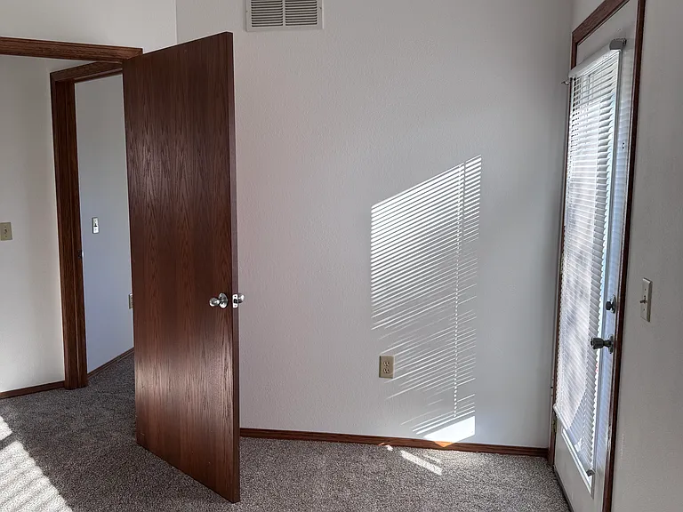 Larger bedroom with vaulted ceiling and back patio door. And large closet.
