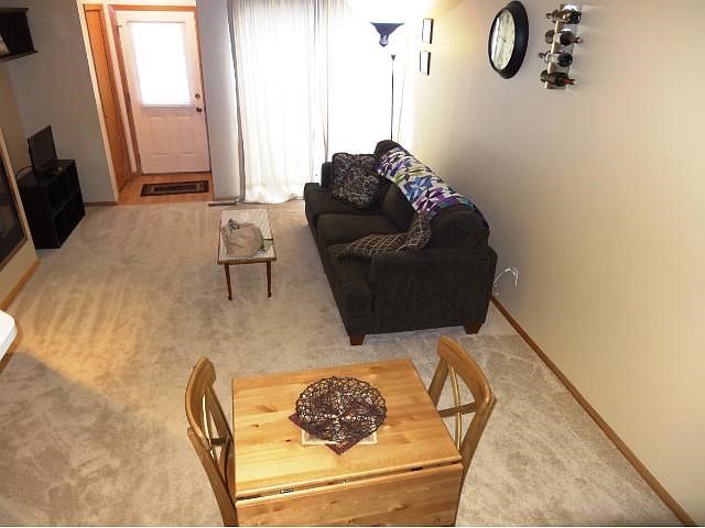 Living room has new carpet and walks out to the patio area