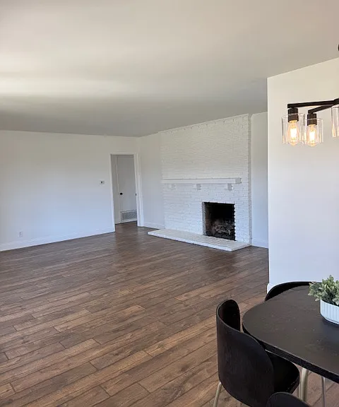 spacious living room with brick gas fireplace