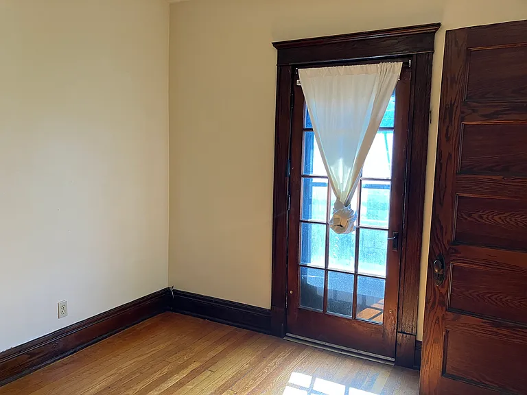 Room off of living room, porch access door and room entry door - open