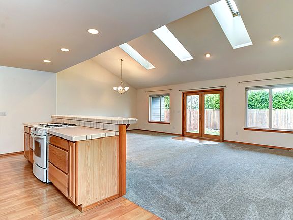 Double doors and large windows to a fully fenced, private backyard.