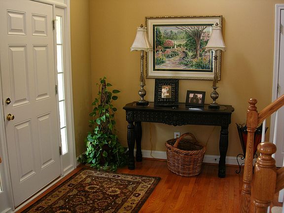 Two story foyer features hardwoods
