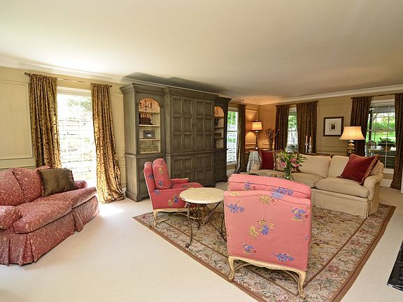 The warm and inviting living room features enameled trim & wool carpet . 