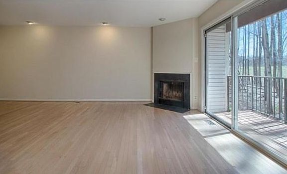 Living area with fireplace and balcony