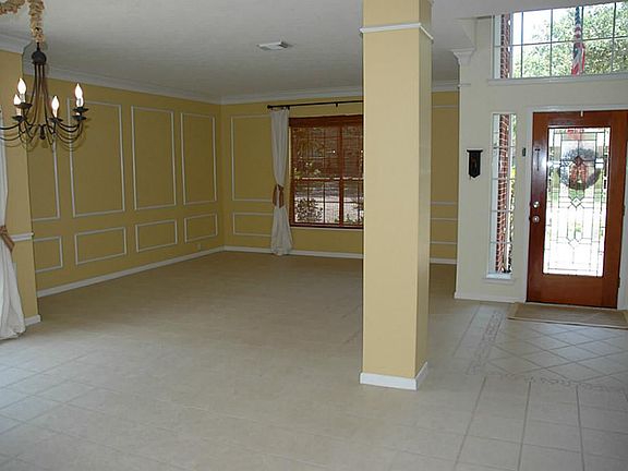 Here is the formal living and dining with the beautiful lead glass front door. Notice the accent tile area near entry.