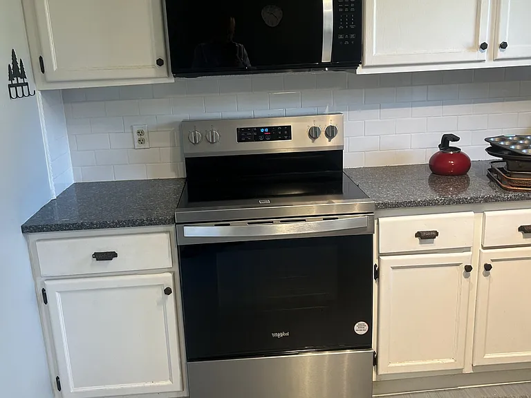 Kitchen includes closet pantry, and new stainless steel range and microwave.