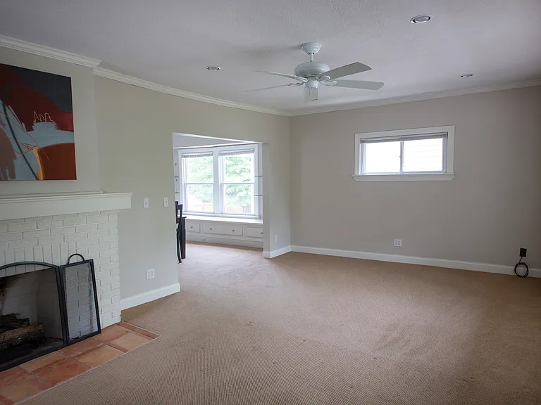 Classic decorative fireplace adds warmth and character to this oversized living area.
