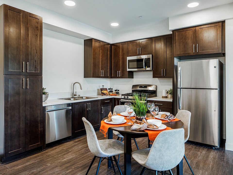 YOLO East dining table and kitchen with appliances