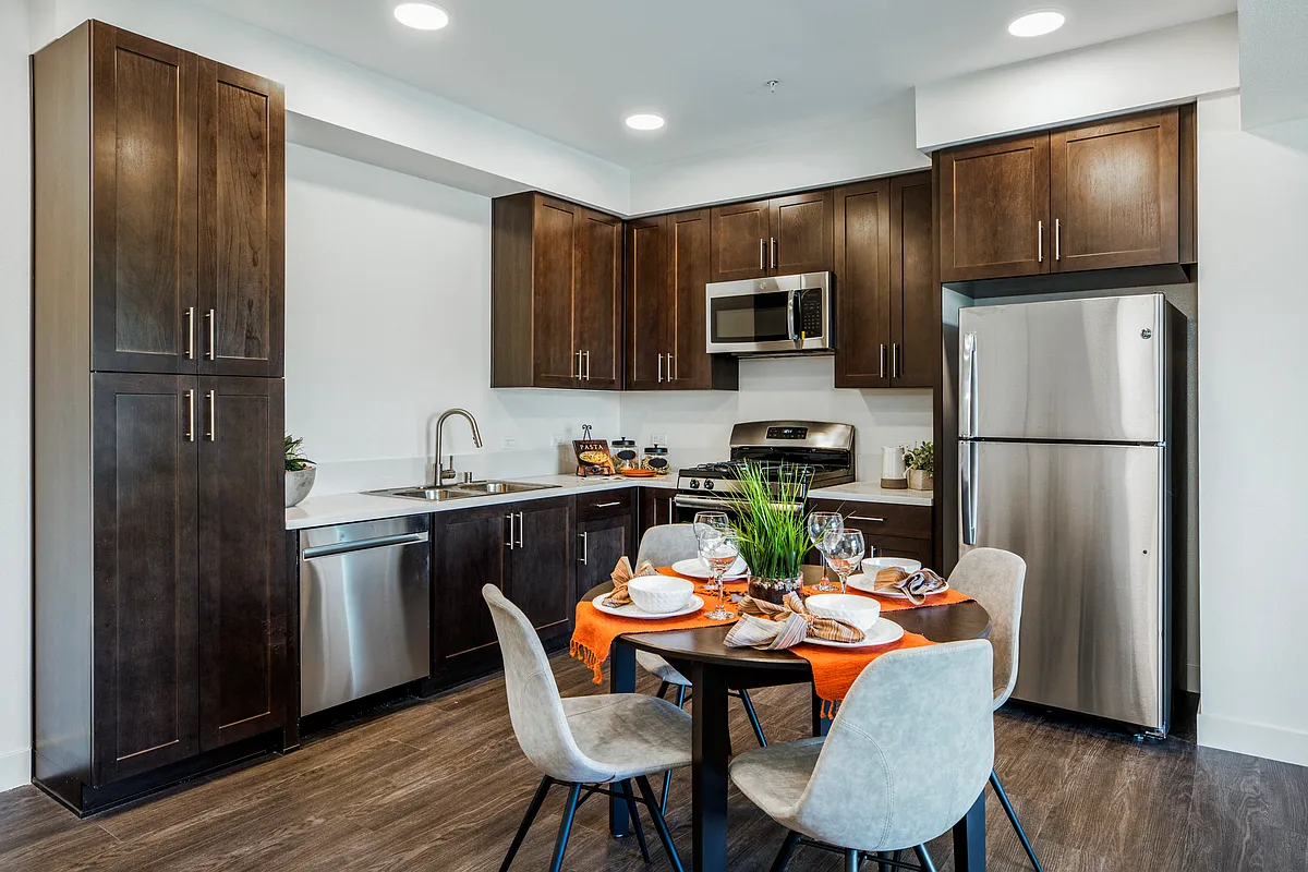 The Harrington dining table and kitchen with appliances - The Harrington