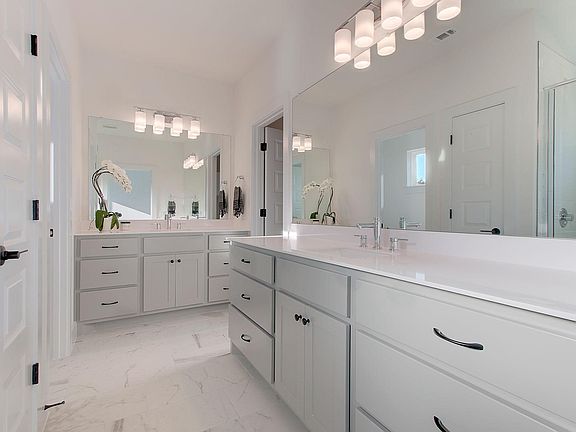 Master bath suite with double vanities and 12 easy close hardwood drawers.
