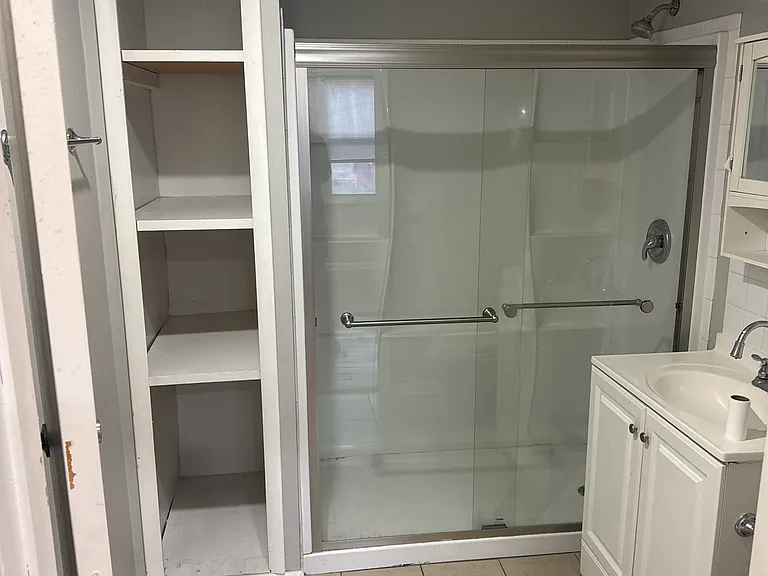 Newly renovated bathroom featuring a sleek stand -up shower - modern finishes throughout.