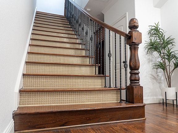 Stairs from the entrance leading to 2nd floor: kitchen, eat in area and living room