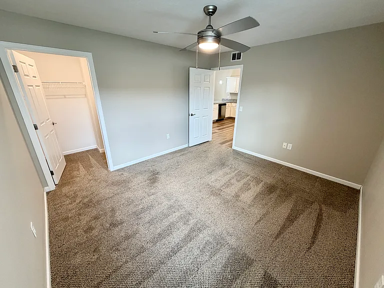 Second angle of guest bedroom with view of walk-in closet