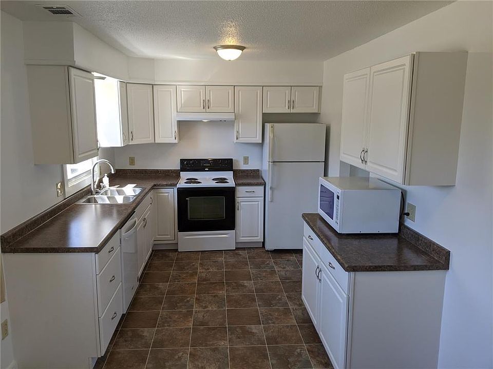 White cabinets and lots of counter space. Window above the sink.