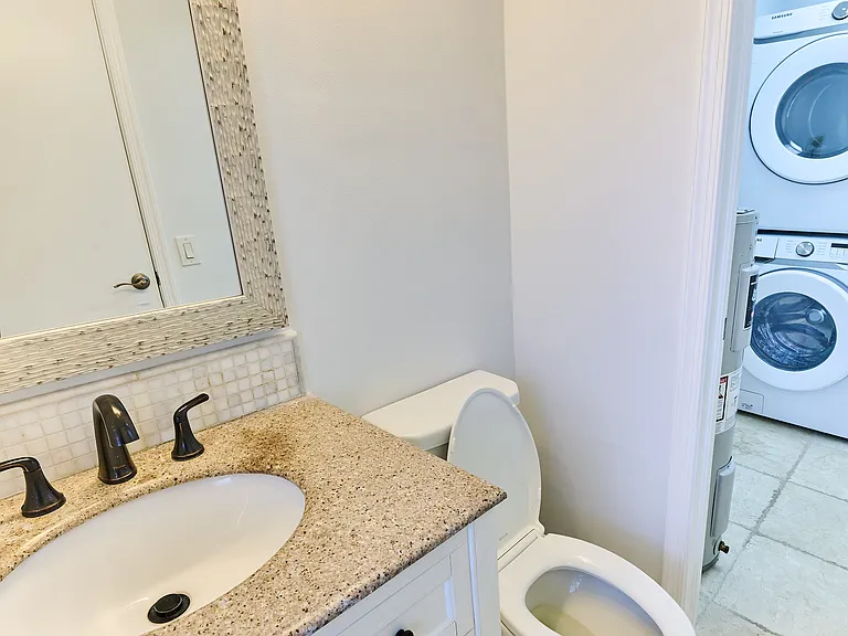 Half-bathroom downstairs view into laundry room
