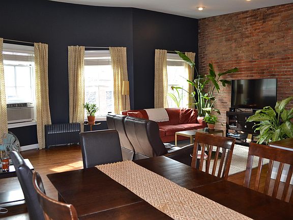 Bright and sunny open floor plan on upper level. Kitchen area in separate picture.