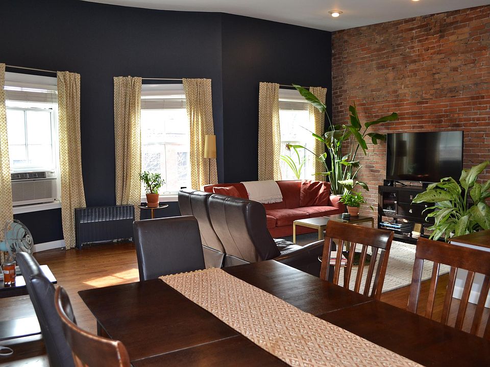 Bright and sunny open floor plan on upper level. Kitchen area in separate picture.