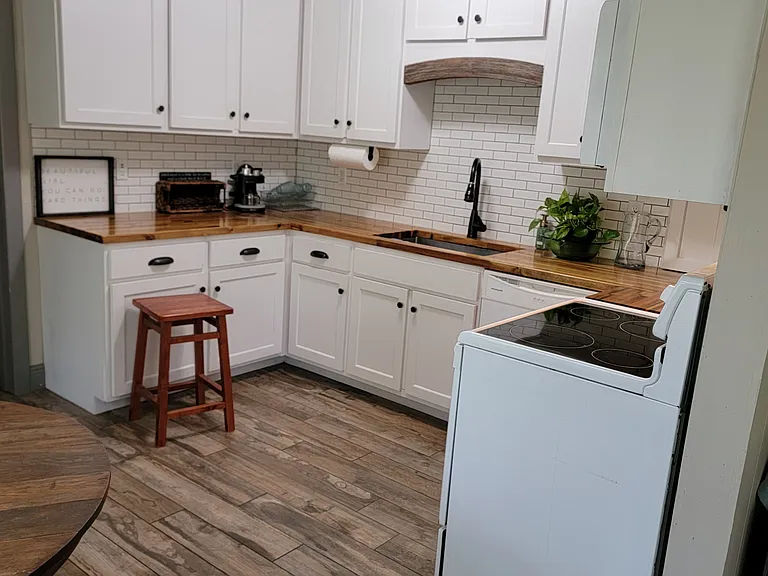 Custom kitchen with dishwasher, microwave and butcher block counters