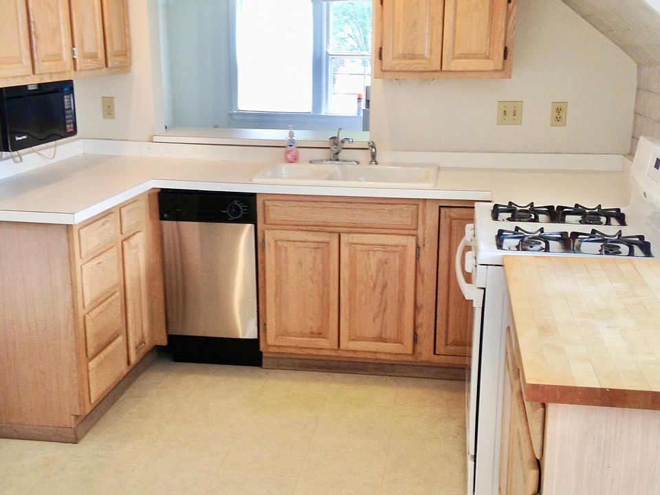 Kitchen with microwave, dishwasher and gas stove.